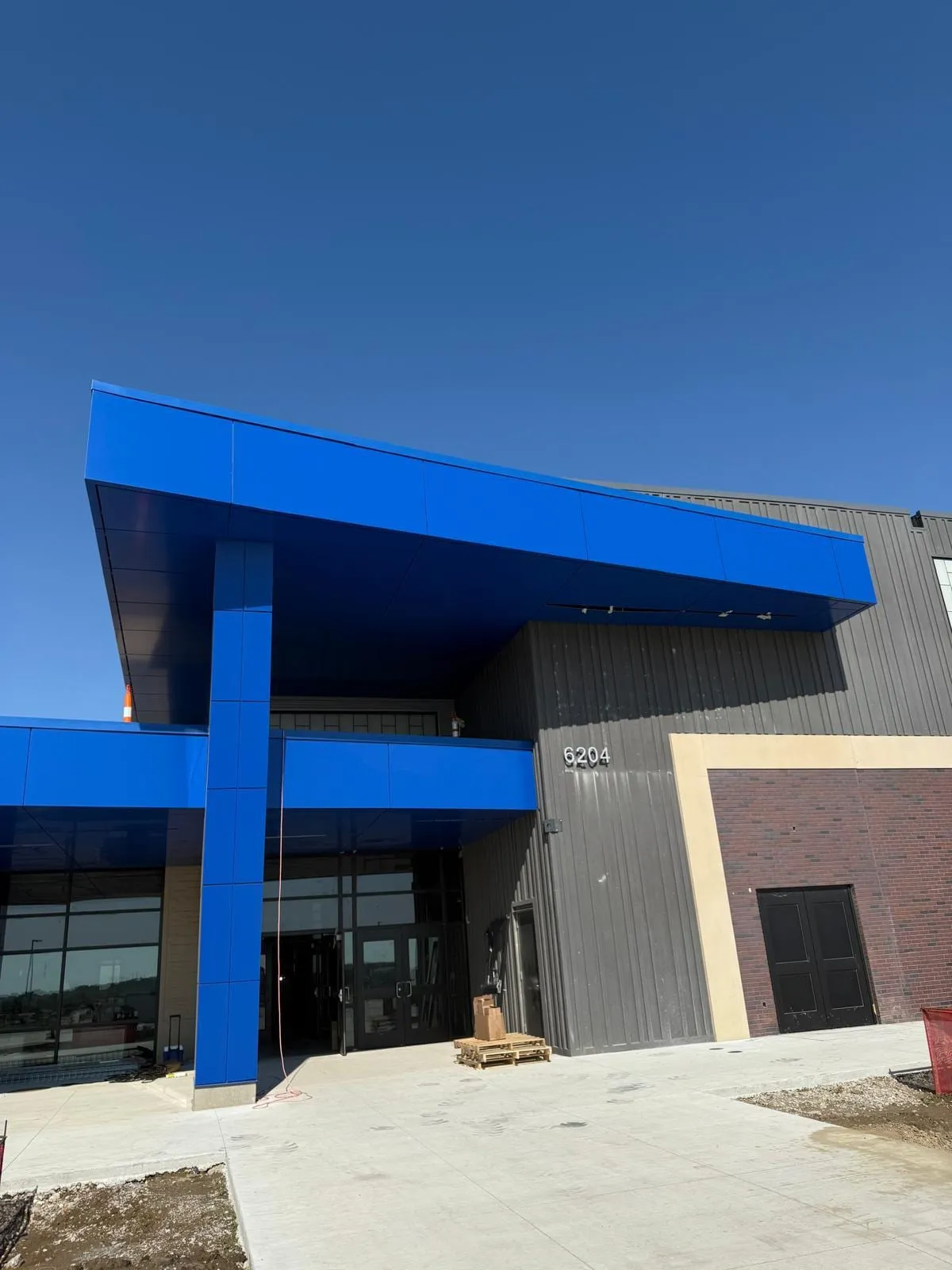 Stone Pointe Elementary — Blue ACM at both entrances — columns, fascias, soffits and transitions — plus Morin wall panel at the rooftop walls. (3/12)