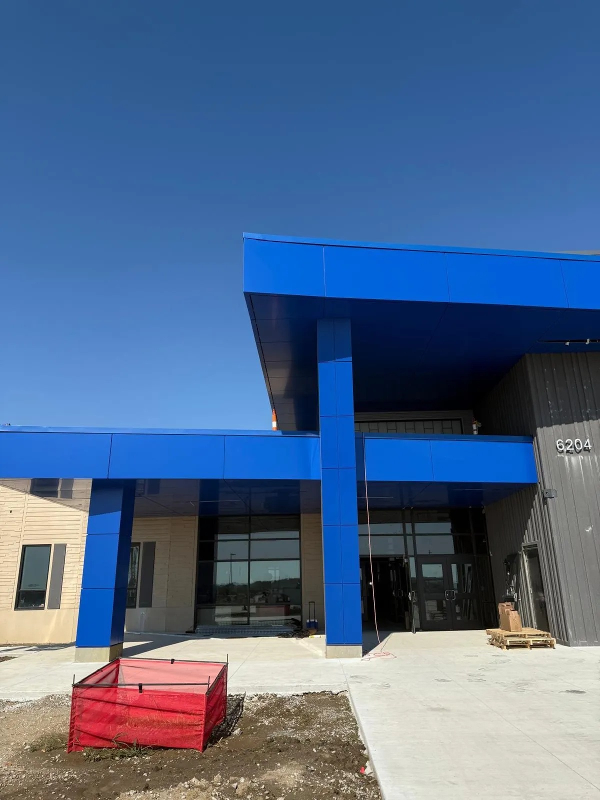 Stone Pointe Elementary — Blue ACM at both entrances — columns, fascias, soffits and transitions — plus Morin wall panel at the rooftop walls. (4/12)