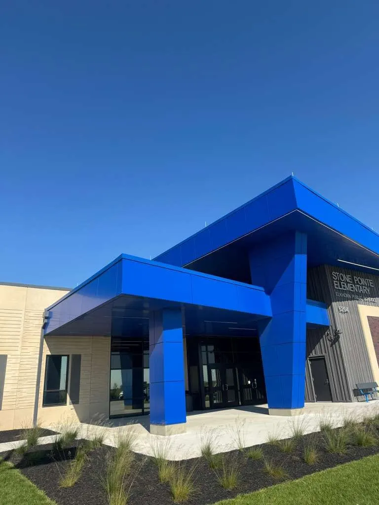 Stone Pointe Elementary — Blue ACM at both entrances — columns, fascias, soffits and transitions — plus Morin wall panel at the rooftop walls. (5/12)