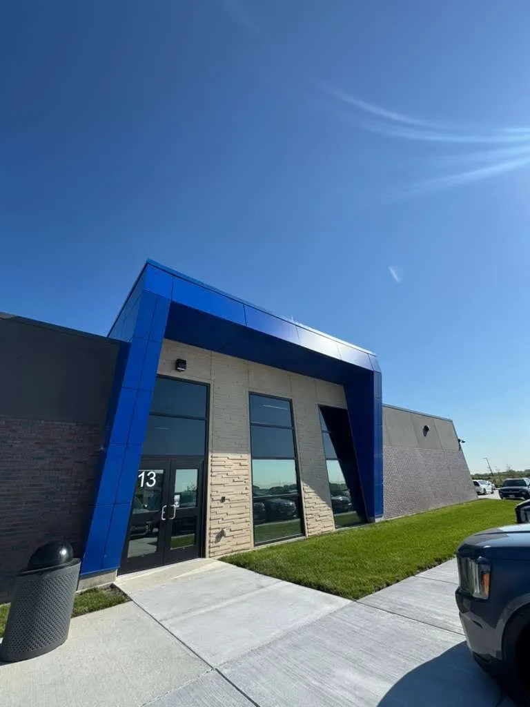 Stone Pointe Elementary — Blue ACM at both entrances — columns, fascias, soffits and transitions — plus Morin wall panel at the rooftop walls. (6/12)