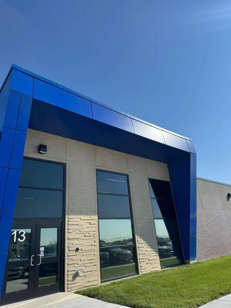 Stone Pointe Elementary — Blue ACM at both entrances — columns, fascias, soffits and transitions — plus Morin wall panel at the rooftop walls. (8/12)