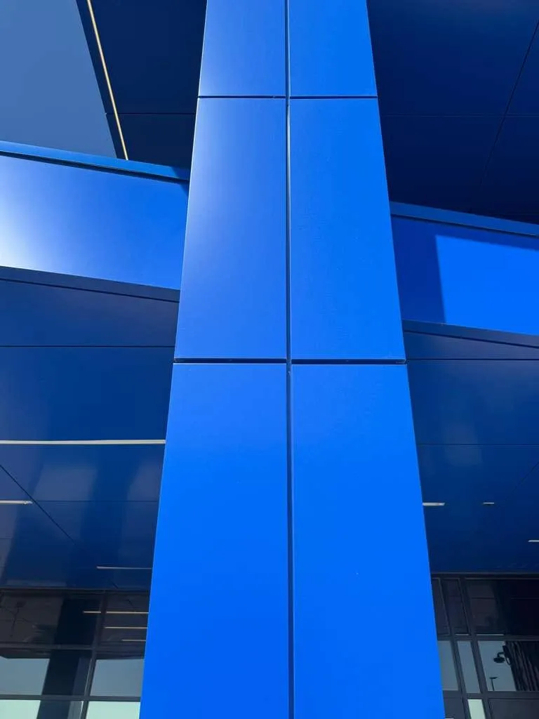 Stone Pointe Elementary — Blue ACM at both entrances — columns, fascias, soffits and transitions — plus Morin wall panel at the rooftop walls. (10/12)