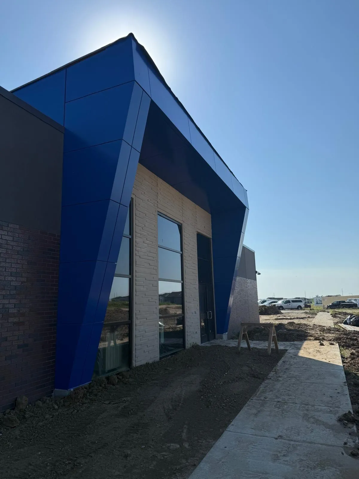 Stone Pointe Elementary — Blue ACM at both entrances — columns, fascias, soffits and transitions — plus Morin wall panel at the rooftop walls. (11/12)
